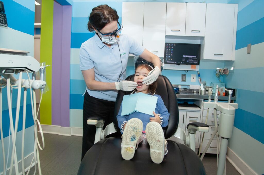 Girl in the dental chair examined by Dr. Sara Babich